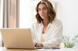 © opolja - Beautiful young woman working from home on laptop.