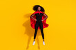 © deagreez - Full length body size photo curly girl jumping high wearing red cover super woman isolated on bright yellow color background