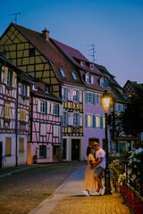 Wall Mural - Colmar, Alsace, France. Petite Venice, water canal, and traditional half timbered houses. Colmar is a charming town in Alsace, France. couple man and women walking at the street during vacation