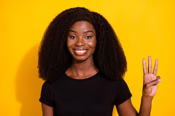 Poster - Photo portrait woman smiling happy showing number three fingers isolated bright yellow color background