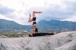 © ADDICTIVE STOCK - Couple practicing acro yoga together in highlands