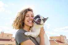 Happy Woman Holding Bulldog. Horizontal View Of Woman With Pet Outdoors. Lifestyle With Animals.