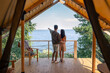 © pressmaster - Backs of young man and woman standing in front of seaside during summer vacation