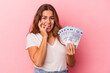 © Asier - Young caucasian woman holding bills isolated on pink background  biting fingernails, nervous and very anxious.