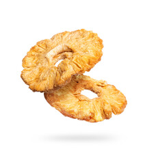 Dried pineapple rings close up in the air on a white background