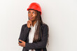 © Asier - Young african american architect woman isolated on white background looking sideways with doubtful and skeptical expression.