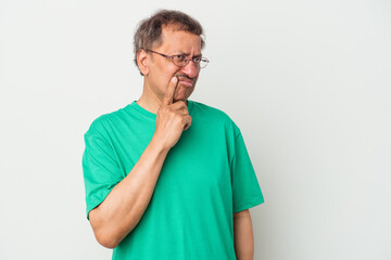 Middle aged indian man isolated on white background looking sideways with doubtful and skeptical expression.