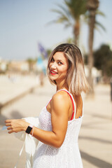 Young hispanic woman standing back to camera and smiling to camera