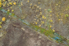 Aerial View Of Country Road Passing Through Wetlands. Natural Pattern Background. Top View Aerial Photo