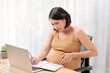 © makistock - Pregnant Woman Using Laptop At Table Working From Home