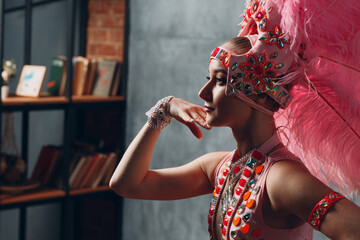 Wall Mural - Woman in samba or lambada costume with pink feathers plumage.