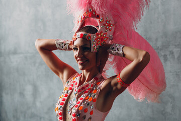 Wall Mural - Woman in samba or lambada costume with pink feathers plumage.