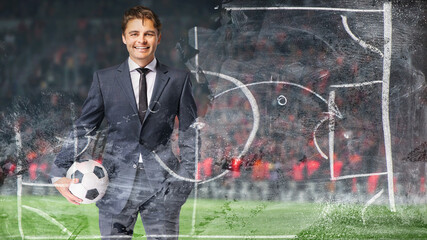 smiling businessman in formal wear with soccer ball in the big stage