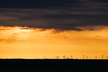 Wall Mural - Wind Turbines renewable energy at sunset 