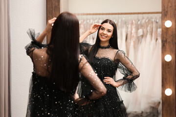 Canvas Print - Woman trying on dress in clothing rental salon