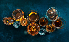 Strong Alcohol Drinks, Hard Liquors, Spirits And Distillates Iset In Glasses: Cognac, Scotch, Whiskey And Other. Blue Background, Top View