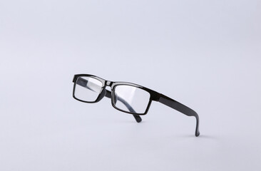 Poster - Levitating eye glasses on gray background