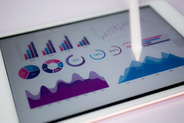 Report graph and chart of investment with finance on tablet computer on desk, datum of stock and growth, planning and statistic with economic, no people, digital marketing, business concept.