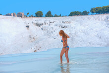Young Girl Is Walking On The Travertines - Natural Travertine Pools And Terraces In Pamukkale. Cotton Castle In Southwestern Turkey