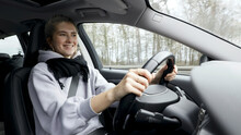 Young Woman With Natural Look Driving A Passenger Car On A German Highway. The Young Woman Shows Various Emotional Reactions To The Traffic Event.