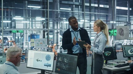 Leinwandbilder - Car Factory Office: Female Engineer Talks with Male Scientist, Use Tablet Computer to Design Production Conveyor for Advanced Power Engines. Automated Robot Arm Assembly Line Manufacturing Vehicles
