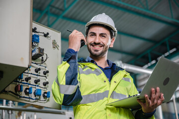 Wall Mural - professional technician engineer working to control electrical power and safety service system, electrician working to maintenance and checking industrial equipment in term of factory technology