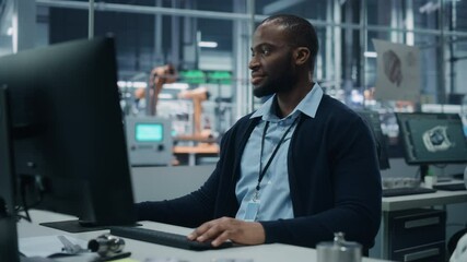 Fototapete - Car Factory Office: Portrait of Confident Black Male Chief Engineer Working on Desktop Computer. Professional Technician in Automated Robot Arm Assembly Line Manufacturing High-Tech Electric Vehicles