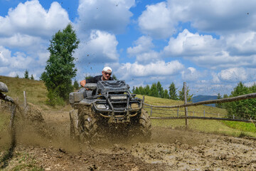 Canvas Print - ATV racing on dirt track at summer mountain