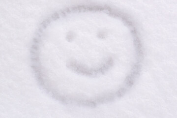 Wall Mural - snow texture close-up smile face is drawn