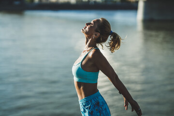 Wall Mural - Woman Doing Relaxation Exercises While Preparing For Outdoors Workout