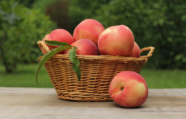 Wall Mural - Basket of Fresh Organic Peaches on table at Market