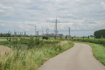 Wall Mural - road in the countryside with industrial complex in background