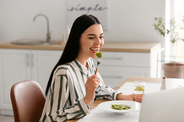 Canvas Print - Beautiful young woman eating tasty ravioli at home