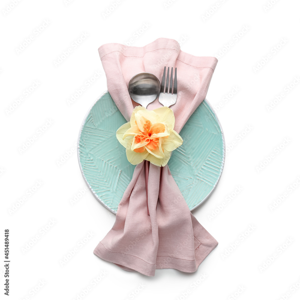 Beautiful table setting with narcissus flower on white background