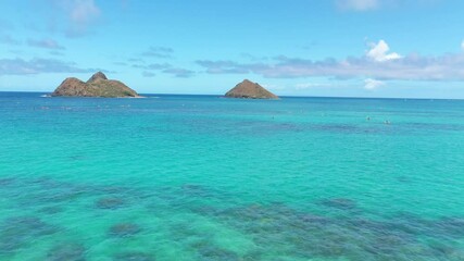 Wall Mural - Aerial view of the twin Mokulua Islands off the coast of Lanikai beach in Oahu, Hawaii, with turquoise water and visible coral reefs in the foreground.