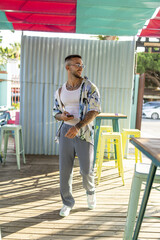 Wall Mural - Vertical shot of a white Caucasian guy posing for a photoshoot in a cafe