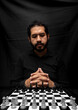 © Narayan - latin man with beard challenging in chess game, chess concept
