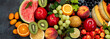 Assorted fresh fruits on dark background.