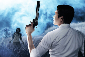 Sticker - Asian man standing with a gun in his hand ready to attack zombies