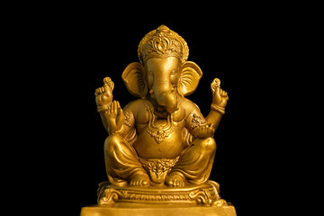 Wall Mural - Golden lord ganesha sclupture over dark background. celebrate lord ganesha festival.