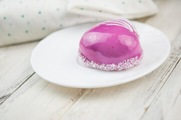 Wall Mural - a cup and heart-shaped cake on a white wooden background