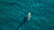 © fotofabrika - Aerial photo of man on sup board in clear blue sea