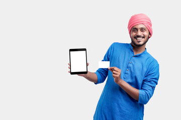 Wall Mural - Young indian farmer showing card and smartphone on white background.