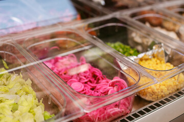 Sticker - Closeup of the salad bar with marinated onions, peppers, corn