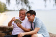 © sutthichai - A man give money to his father.Financial and saving concept.