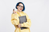 Fototapeta  - A female designer in yellow hoody holding a graphic tablet.
