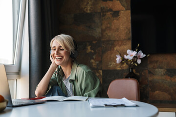 Sticker - Middle aged blonde woman with short hair studying