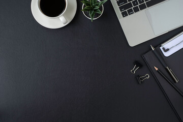 Wall Mural - Black leather office desk table. Workspace with keyboard of laptop computer and pen, equipment other office supplies. Top view with copy space, flat lay.