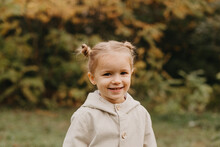 Portrait Of A Little Cute Girl Walking In The Autumn Park