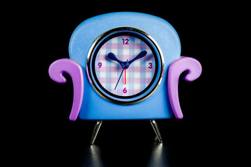 Vintage alarm clock on black background.